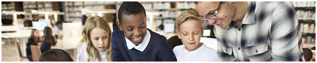 teacher and three students in library