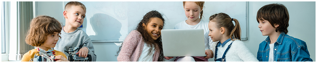 two students holding robots other four students looking at laptop