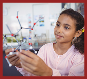 student examining a molecule model