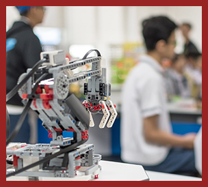 robotic lab with students in background and a robot in foreground